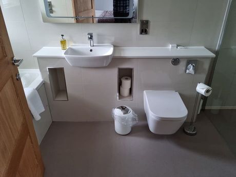 Bathroom installation with a toilet, sink, bath, and shower